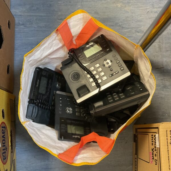 A bag of multiple Yealink office phones for business communication.