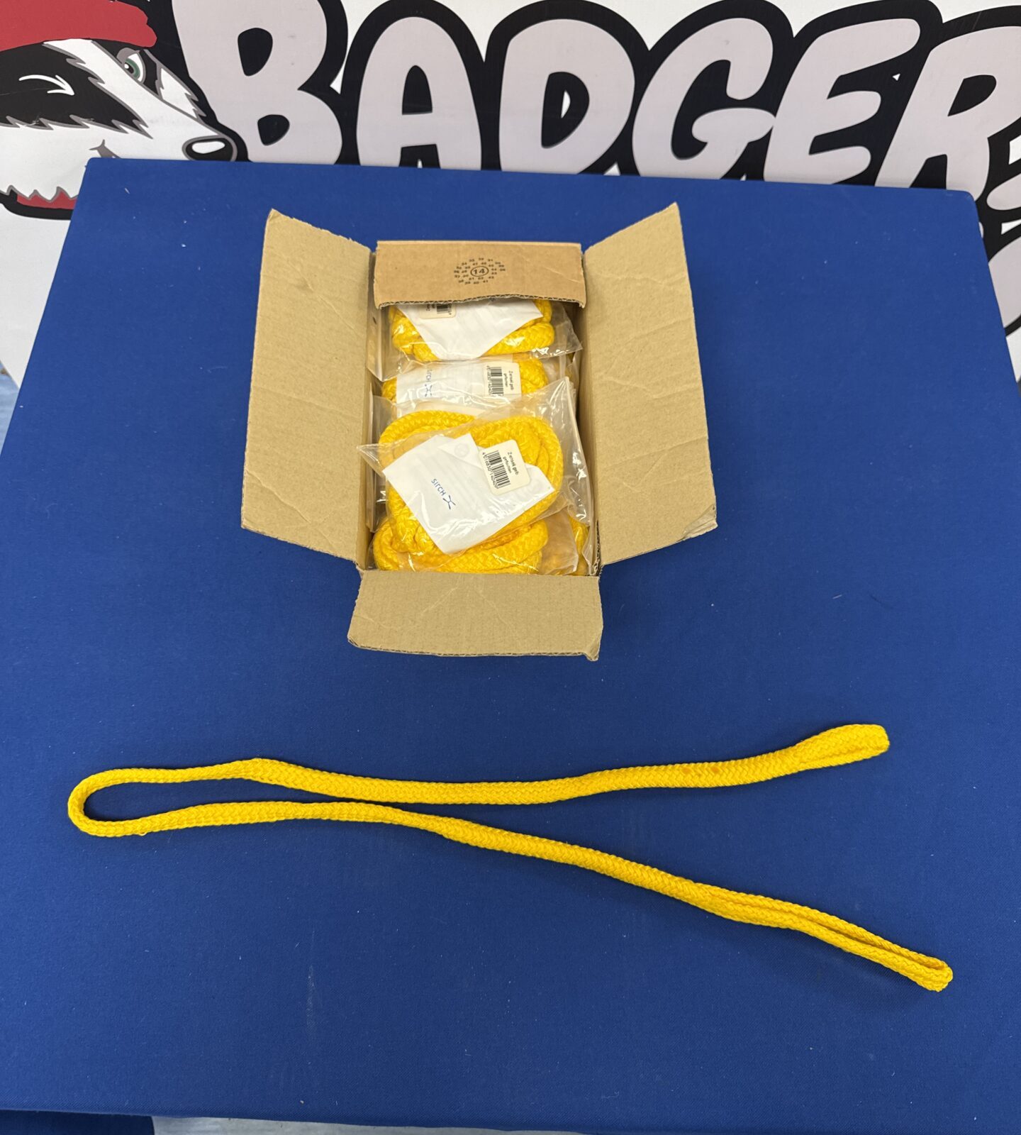 Bright yellow nylon rope with loop ends in original packaging.