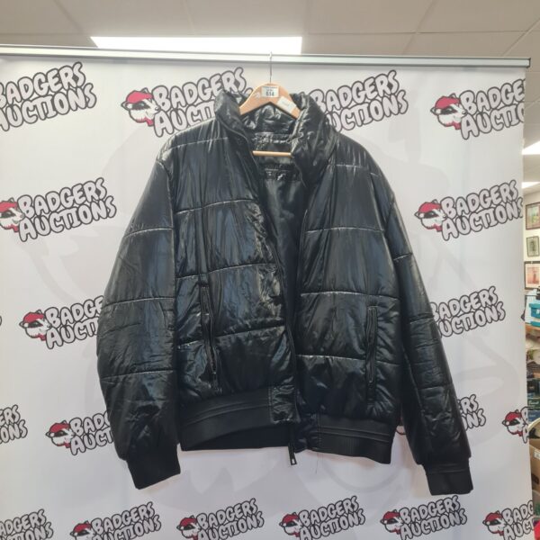 Black Zara puffer coat women's size XL for winter warmth.
