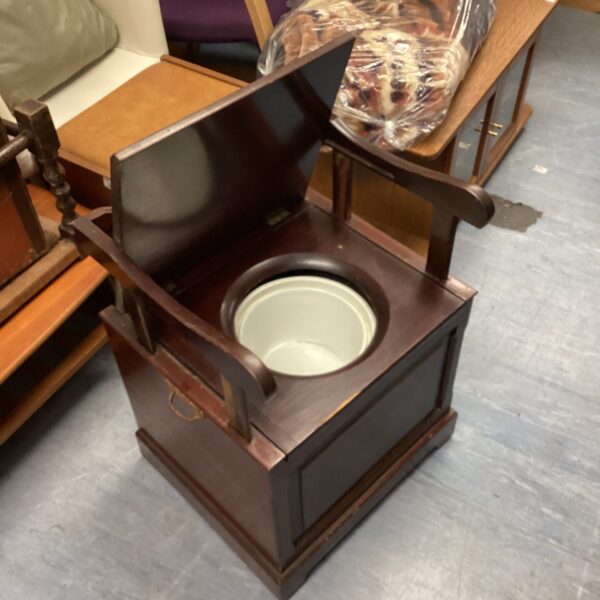 Antique 19th-century mahogany commode with lift-up lid.