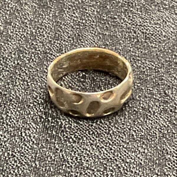 Close-up of a textured 925 silver ring, size M.
