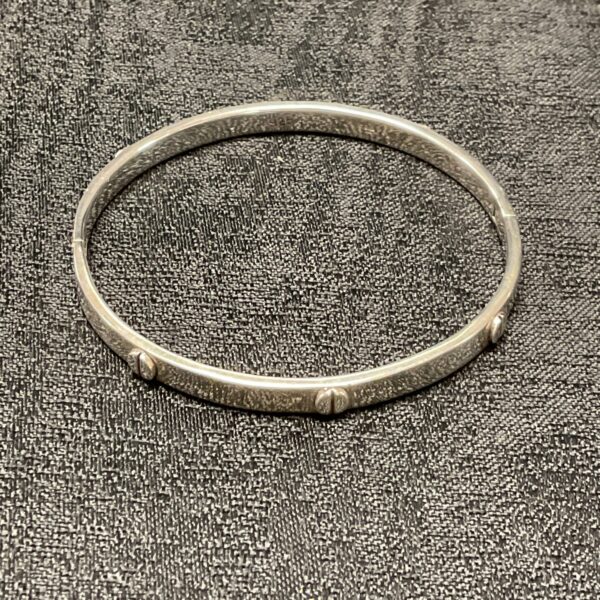 Close-up of vintage 925 silver screw bracelet.