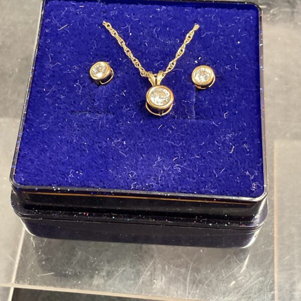 9ct gold necklace and earrings set with white stone.