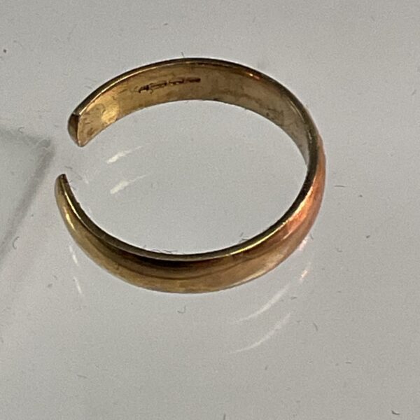 Close-up of delicate 9ct gold toe ring.