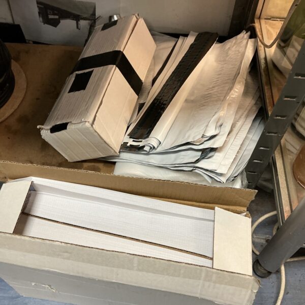 Box of A4 white envelopes with plastic sealable bags.