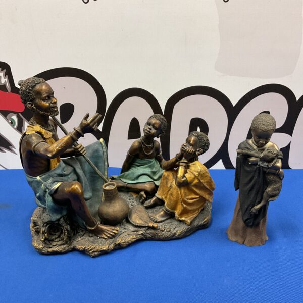 Detailed resin African storyteller sculpture with girl and lamb.