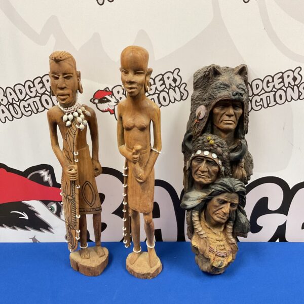 Hand-carved African tribal figures and Native American bust for collectors.