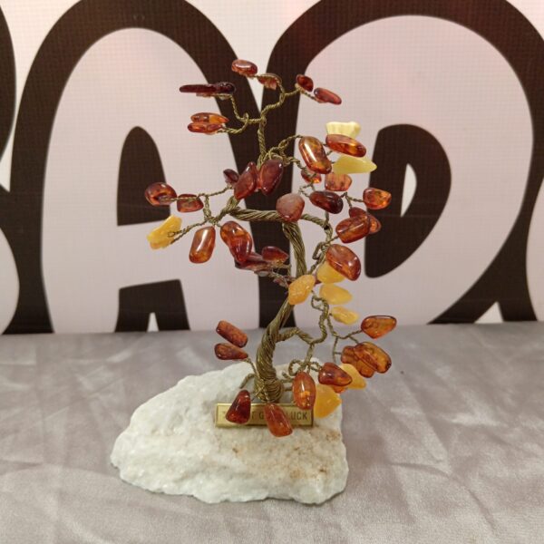 Decorative amber tree of luck on stone base.