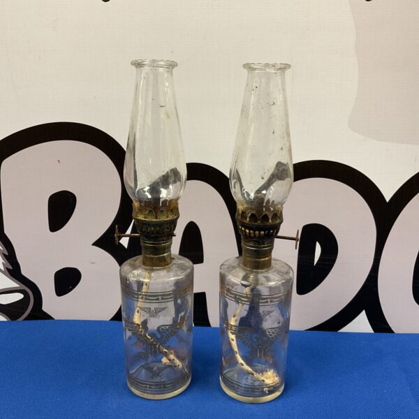 Vintage pair of American Eagle oil lamps with glass reservoirs.