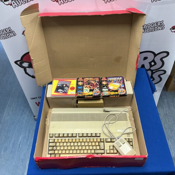 Boxed Commodore Amiga 500 Plus computer with games and accessories.