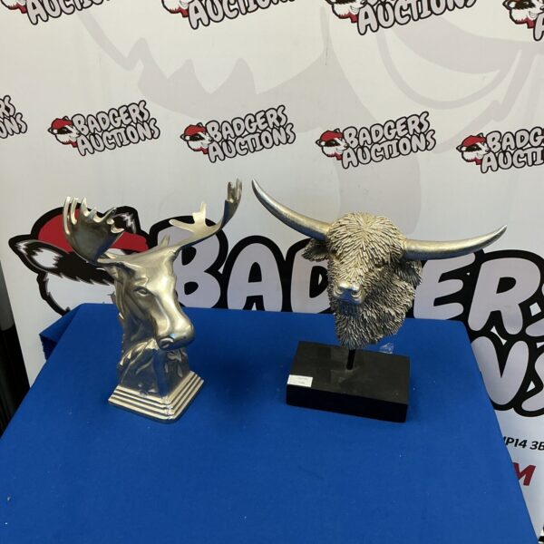 Decorative animal busts of a ram and boar for home decor.