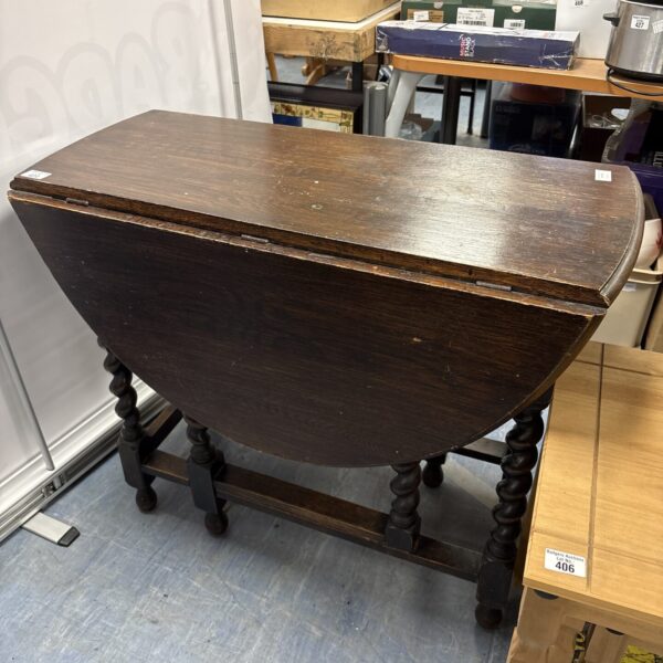 Dark oak antique barley twist gate leg table with folded legs.