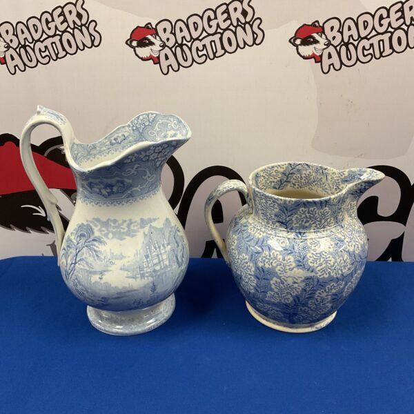 Antique blue and white porcelain jugs with transfer printed designs.