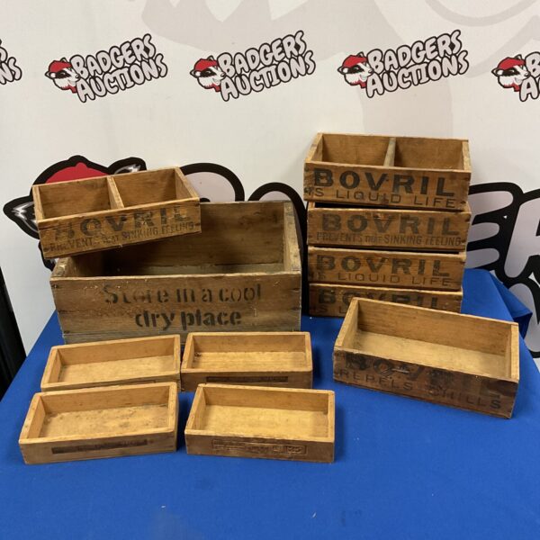 Antique wooden shop display boxes featuring Bovril and Camel branding.
