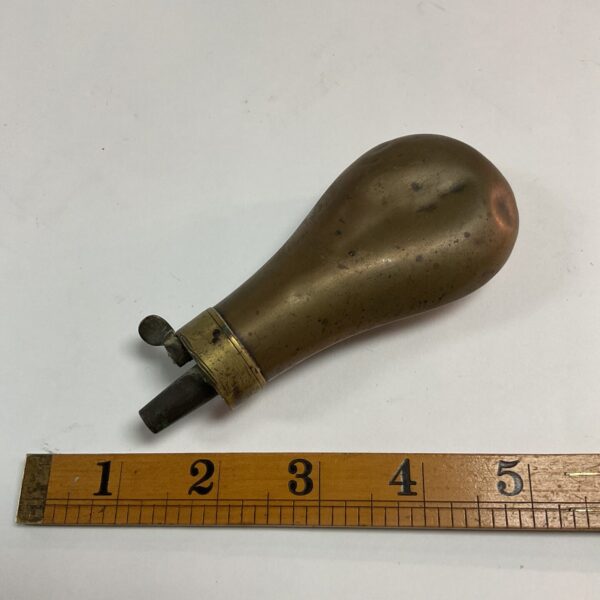 Antique brass and copper powder flask for muzzle-loading firearms.