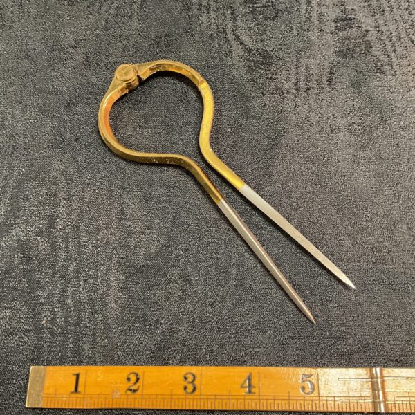 Antique brass navigation dividers by W & H C for nautical charting.