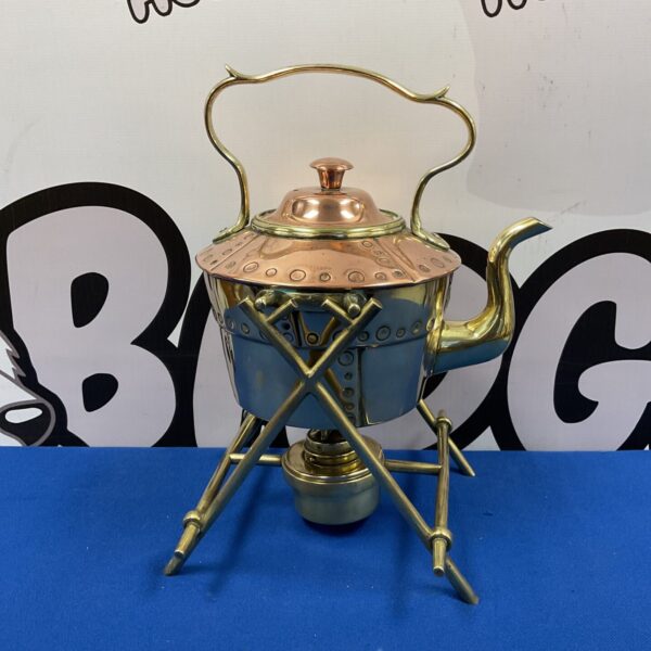 Antique copper spirit kettle with brass studs and legs.
