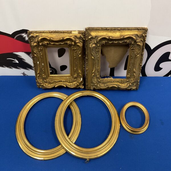 Lot of five antique gilt picture frames with ornate detailing.