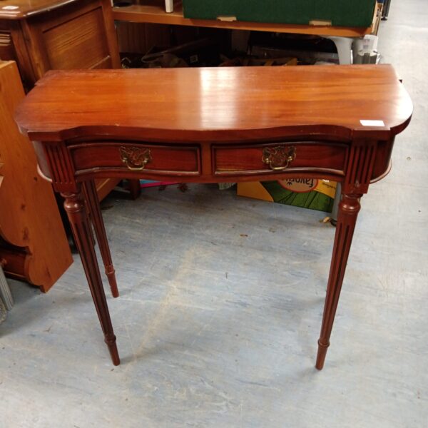 Antique mahogany console table with bow front and two drawers.