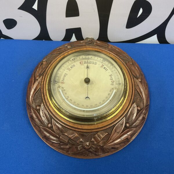 Antique mercury wall barometer with carved oak case.