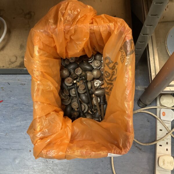 Lot of antique metal knobs and handles for furniture restoration.