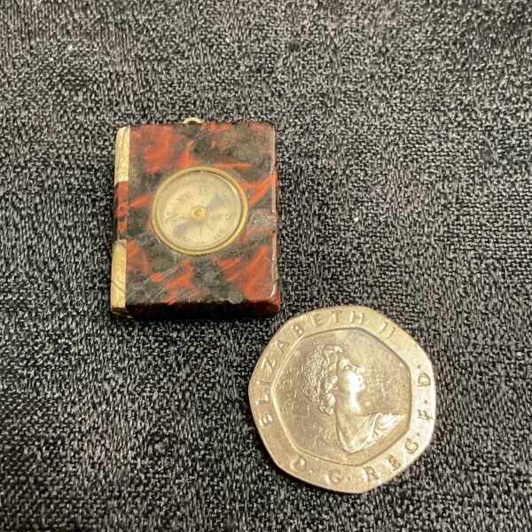 Antique miniature compass book with serpentine stone cover.