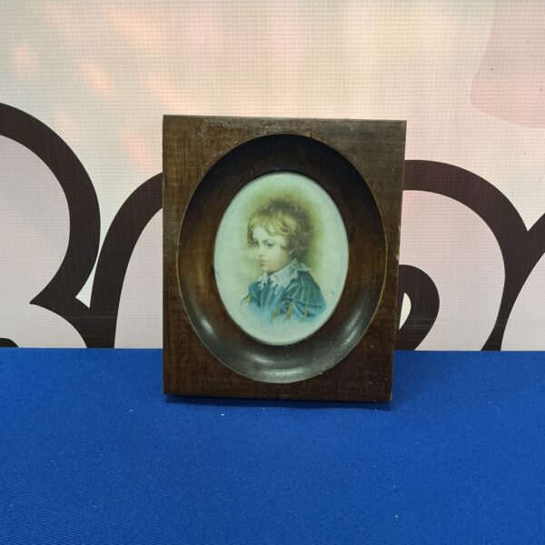 Antique silk miniature portrait of a 17th century boy in oval frame.