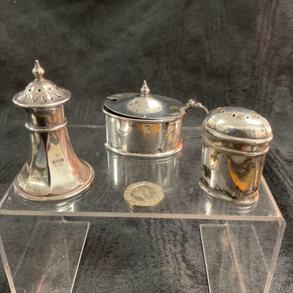 Antique sterling silver pepper pot, mustard pot, and pepper shaker set.