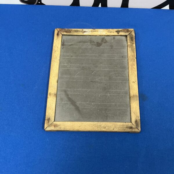 Antique slate chalkboard with wooden frame, vintage school item.