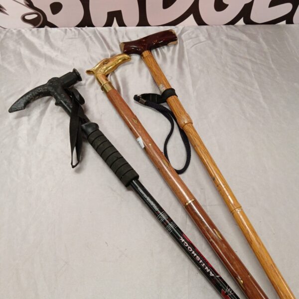 Lot of three antique walking sticks with brass details.