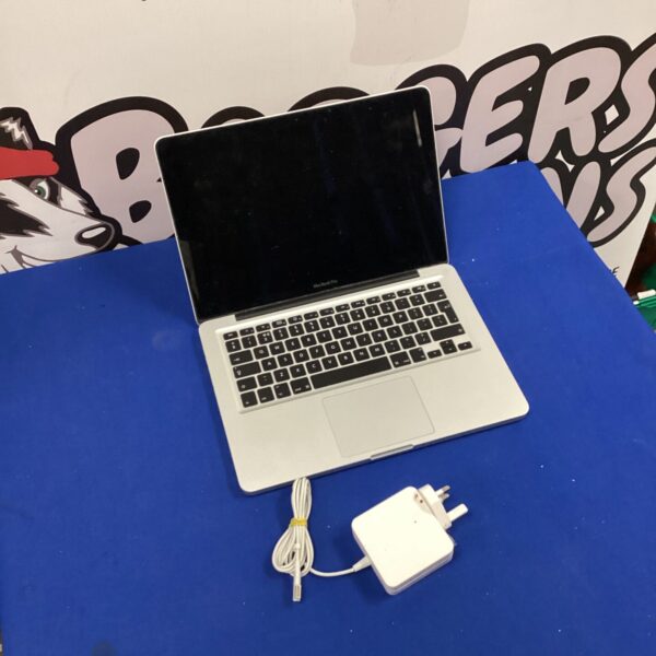 Silver Apple MacBook Pro laptop with charger for auction.