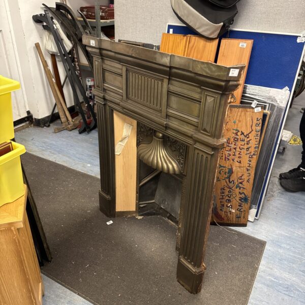 Vintage art deco cast iron fireplace with geometric detailing.