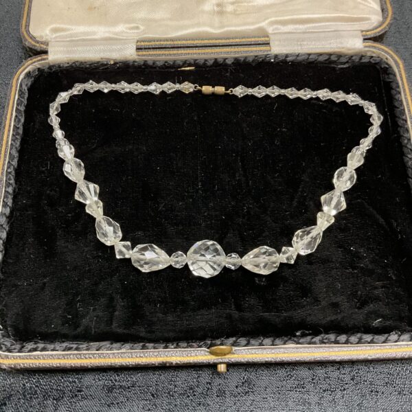 Vintage Art Deco rock crystal necklace displayed in its original box.