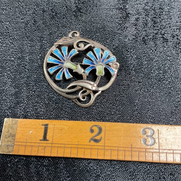 Vintage Art Nouveau silver brooch with colourful enamel flowers.