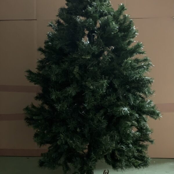 Large artificial Christmas tree with green needles and metal base.