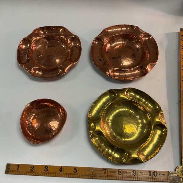 Four Arts and Crafts hand hammered dishes in copper and brass.