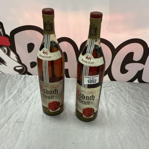 Two vintage bottles of Asbach Uralt German brandy.