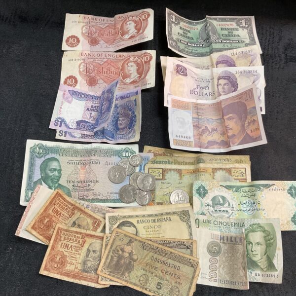 Assorted vintage bank notes and coins in a collectible lot.
