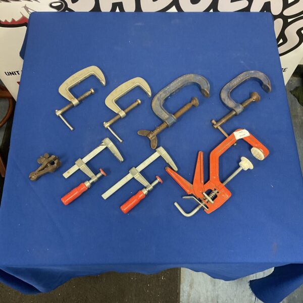Vintage assorted clamps including Record brand woodworking tools.