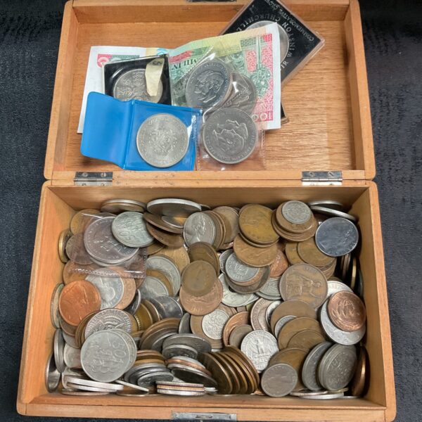 Assorted coin lot in a vintage cigar box, collectible currency.