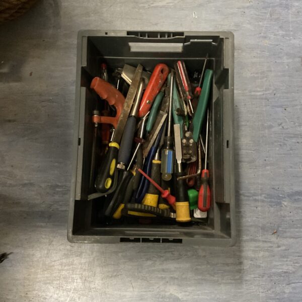 Assorted hand tools in a plastic tub, vintage tool collection.