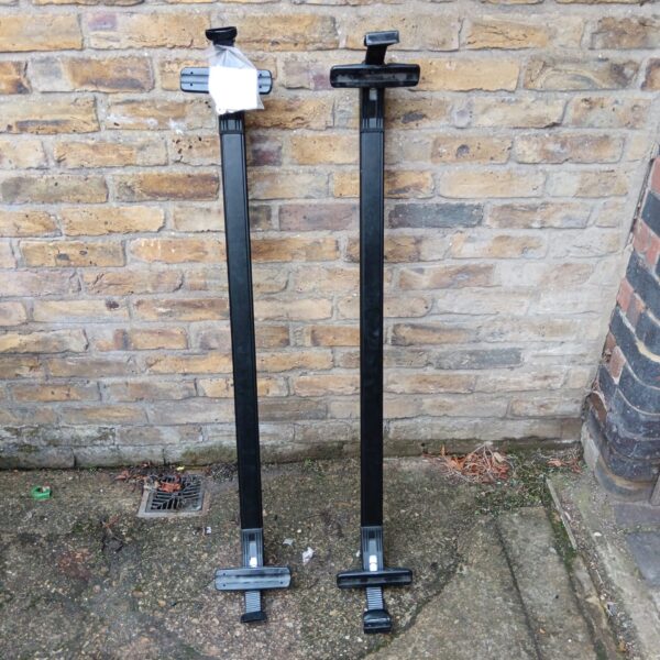 Black Audi as3 roof bars with locking mechanisms for vehicle transport.