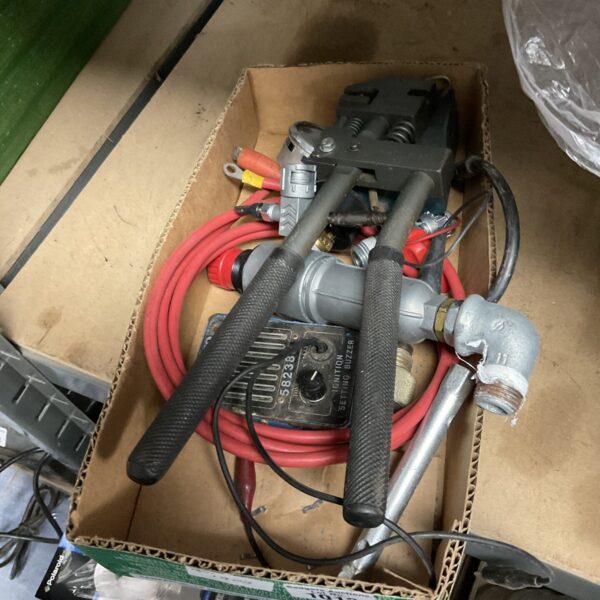 Automotive crimping tool with red and black handle.