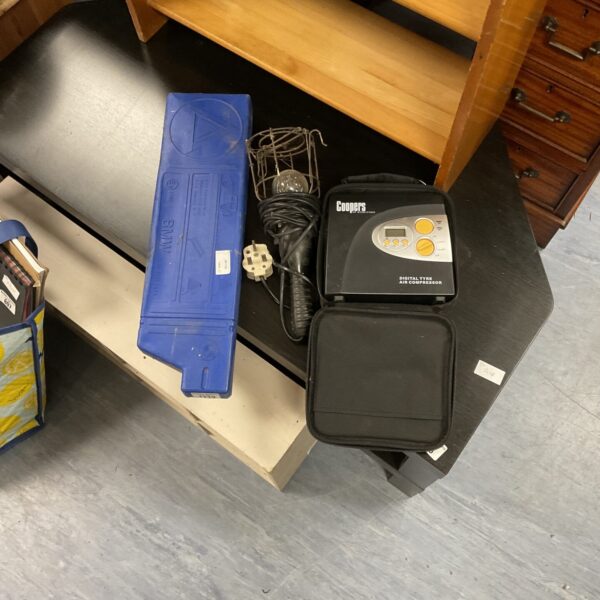 Automotive emergency kit with warning triangle, lamp, and tyre inflator.