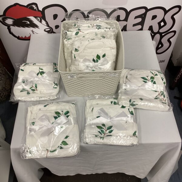 Stack of baby onesies with a leaf pattern, ideal for infants.