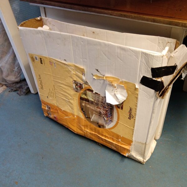 Damaged Babydan playpen packaging showing wear and tear.