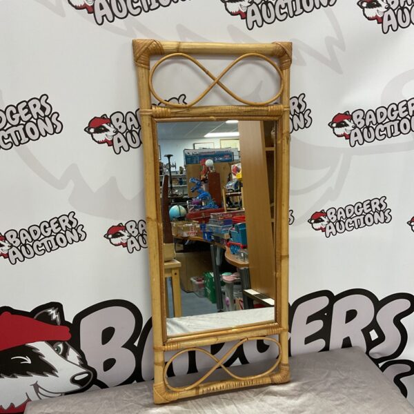 Vintage bamboo wall mirror with a natural rattan frame.