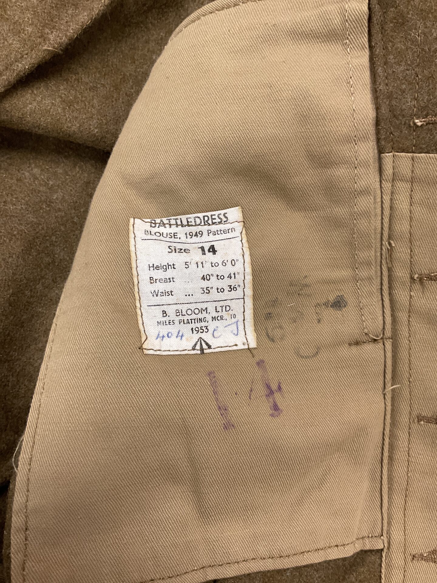 Label on the Battle Dress blouse showing size 14.