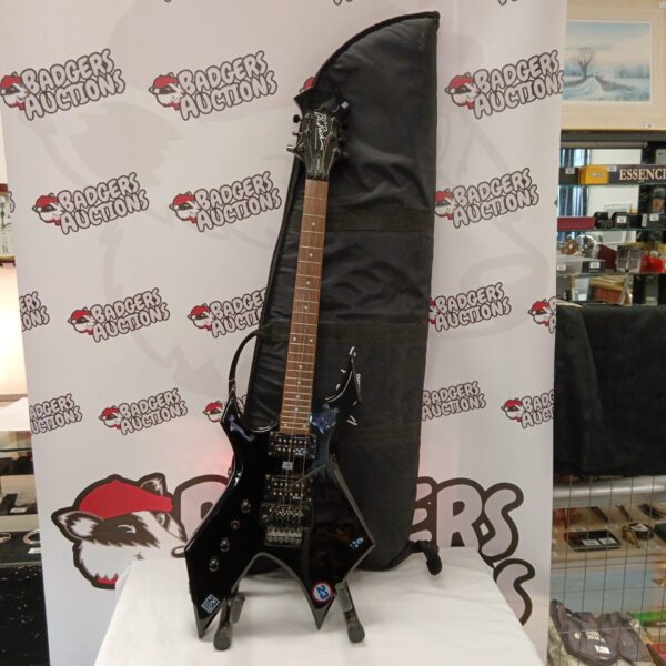 Black B C Rich Warlock electric guitar with case.