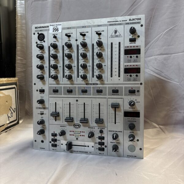 Behringer DJX700 professional DJ mixer with controls and connections.